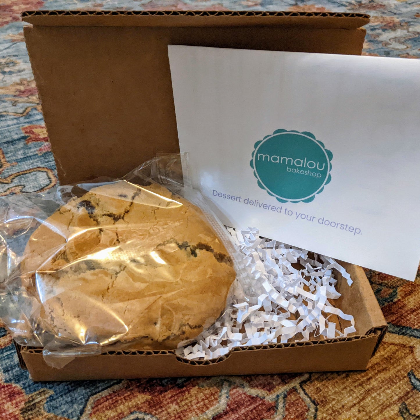 A giant cookie in a box that includes a personalized note