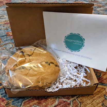A giant cookie in a box that includes a personalized note
